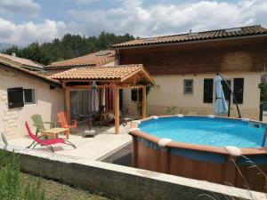 a swimming pool in front of a house at LE CHAMOIS DORT in Die