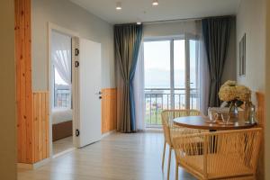 a dining room with a table and a balcony at Silence hotel in Cholpon-Ata