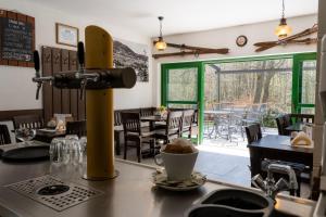a restaurant with a table with a cup of coffee at Chata Rozhlas in Železná Ruda