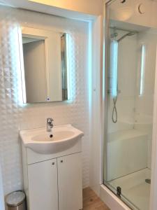 a white bathroom with a sink and a shower at Villa Bianca in Mikołajki +48 photos
