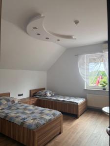 two beds in a room with a window at Noclegi i Restauracja Gracja in Bełchatów +58 photos