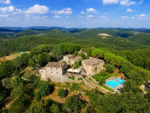 an estate in the hills with a swimming pool at Borgo Livernano in Radda in Chianti