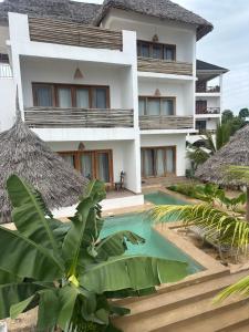 an exterior view of a resort with a swimming pool at Lala salama Kendwa villas in Kendwa