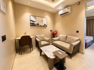 a living room with a couch and a table at Livora Elite in Ghaziabad