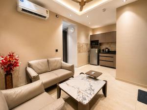 a living room with a couch and a table at Livora Elite in Ghaziabad