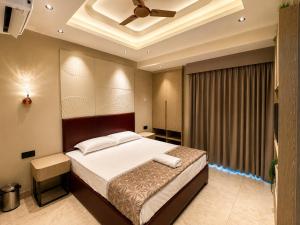 a bedroom with a bed and a ceiling fan at Livora Elite in Ghaziabad