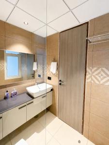 a bathroom with a sink and a shower at Livora Elite in Ghaziabad +5 photos