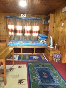 a room with a bed and a table and a rug at Sagun's Place in Phāphlu