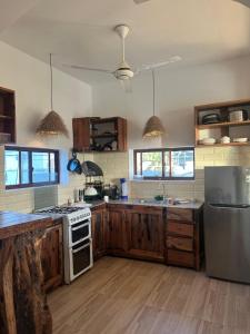 a kitchen with a stove and a refrigerator at Lala salama Kendwa villas in Kendwa