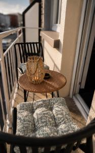 a table and a chair on a balcony at L'éclat du phare in Calais