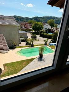 a view of a swimming pool from a window at Apartment Prinz Luis in Owingen