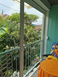 a balcony with a table and a view of trees at Apartman Ex-Yu in Španjola +1 photo