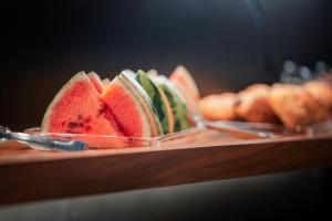 a bunch of watermelon slices on a plate on a table at Hotel Bellerive in Zermatt