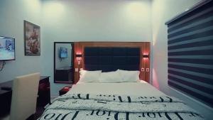 a bedroom with a large bed in a room at Riverleaf Hotels and Suites in Asaba