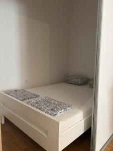 a bed in a small room with a mirror at Apartment MareMare Budva in Rafailovici