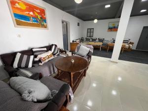 a living room with two couches and a table at Maison chez Hassan in Wassane