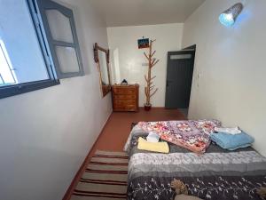 a small bedroom with a bed and a window at Maison chez Hassan in Wassane