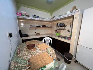 a small kitchen with a table and a sink at Maison chez Hassan in Wassane