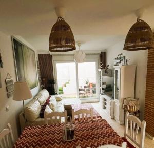 a living room with a couch and a table at Casa Maldo in Tarifa