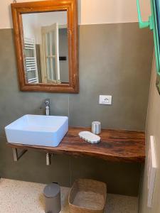 a bathroom with a white sink and a mirror at Assunta Affittacamere in Vitigliano +37 photos