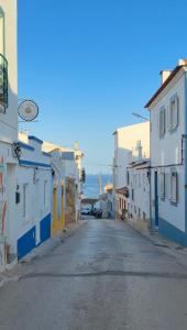 an empty street in a town with buildings at Casa Lua Guesthouse in Burgau