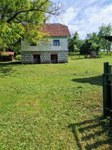 a stone house in the middle of a field at Vila Jelka in Kremna