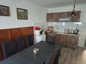 a kitchen with a table and chairs in a room at Vila Jelka in Kremna