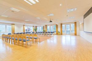 a large room with chairs and a screen in it at Flackl - Wirt in Reichenau