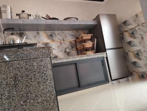 a kitchen with a counter and a refrigerator at Oualidia in Oualidia