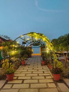 an archway with lights and potted plants at cascade island in Kollam