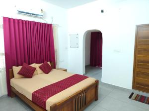 a bedroom with a bed with purple curtains at cascade island in Kollam