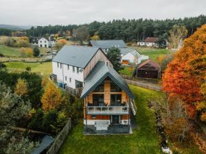 an aerial view of a house in a village at Strathspey Lodge in Duthil