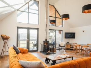 a living room with a couch and a table at Strathspey Lodge in Duthil