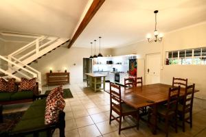 a kitchen and living room with a table and chairs at Cottage on 10th in Gqeberha