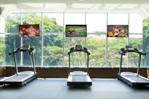 a gym with three exercise bikes in front of a window at wyndham panbil sanctuary in Kangboi