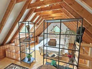 an attic room with a bed and two glass shelves at The Loft House in Canford Magna