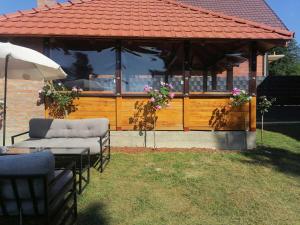 a gazebo with two chairs and a table and an umbrella at Brvnara Aleksandra Tara Sekulić in Konjska Reka
