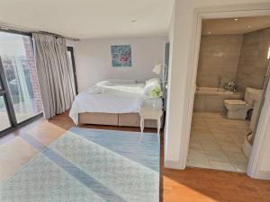 a bedroom with a bed and a bathroom with a tub at Barn Owl Cottage - Uk48510 in Kirk Hammerton