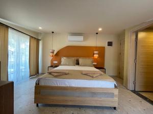 a bedroom with a large bed and two lamps at Lina Life in Fethiye
