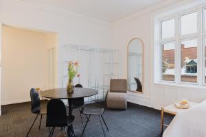 a white room with a table and chairs and a bed at Nomad Hotel - Frederiksberg in Copenhagen +82 photos