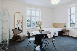 a hotel room with a bed and a table and chairs at Nomad Hotel - Frederiksberg in Copenhagen