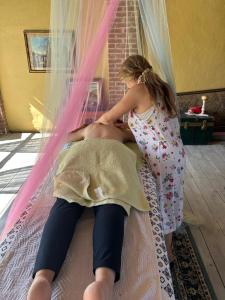 a woman is helping a man on a bed at Casale di Anna in Piea