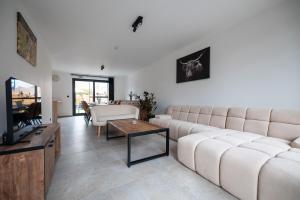 a living room with a couch and a table at Klein Lauw 39 in Tongeren