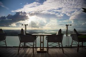 a table and chairs on a balcony with a view at wyndham panbil sanctuary in Kangboi