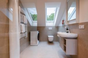 ein Badezimmer mit Waschbecken, Toilette und Fenstern in der Unterkunft Soley70 in Neumarkt in der Oberpfalz
