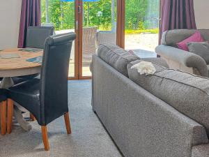 a dog sleeping on the couch in a living room at Mountshade in Finzean