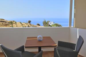 a table and chairs with a view of the ocean at Aethra Seaview Suites in Kerames