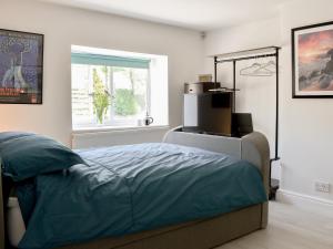 a bedroom with a bed and a window at Morton Loft in Hathersage