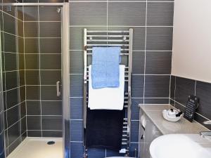 a bathroom with a shower with a sink and a toilet at Cairn View in Strachan +1 photo