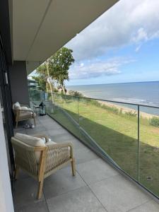 a balcony with a view of the ocean at Hevenia Klifowa 5 B Apartament 33 in Rewal